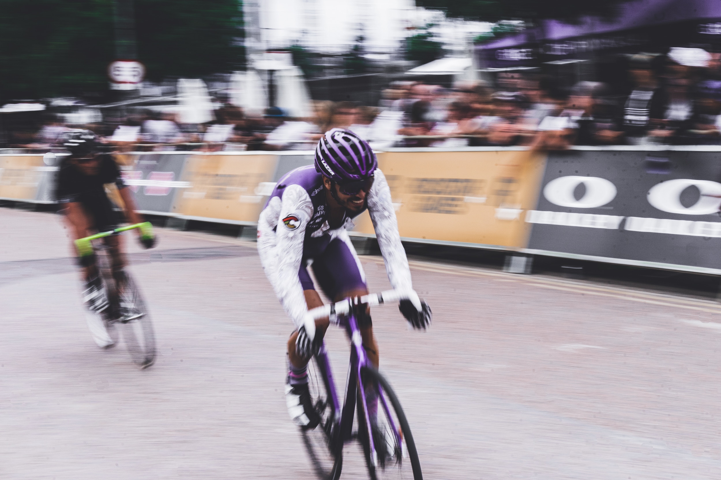 A motion-blurred image of two bike riders during a race.